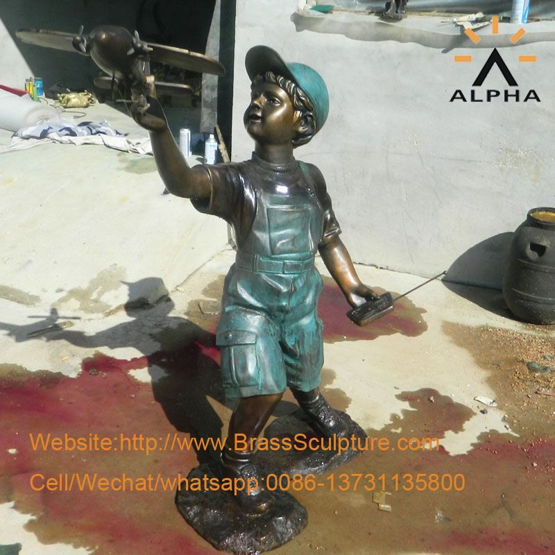 The bronze boy with airplane statue sculpture